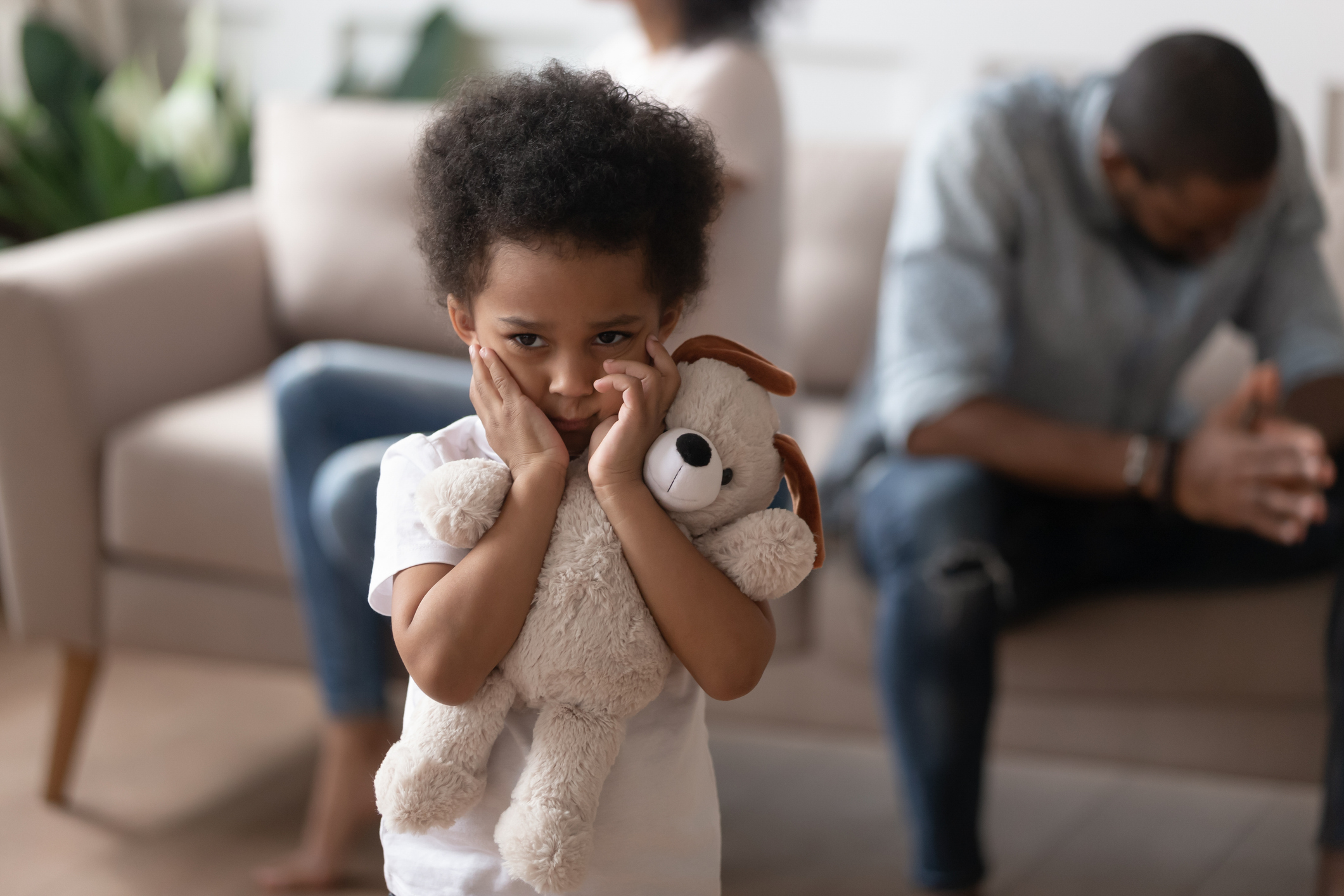 Image of small child holding a teddy bear.