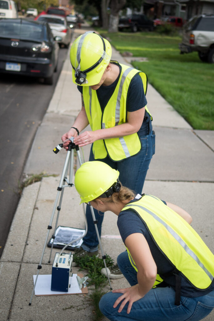 Research team members prepare air sampling equipment to collect a measurement. Image credit: Ritu Pandit 