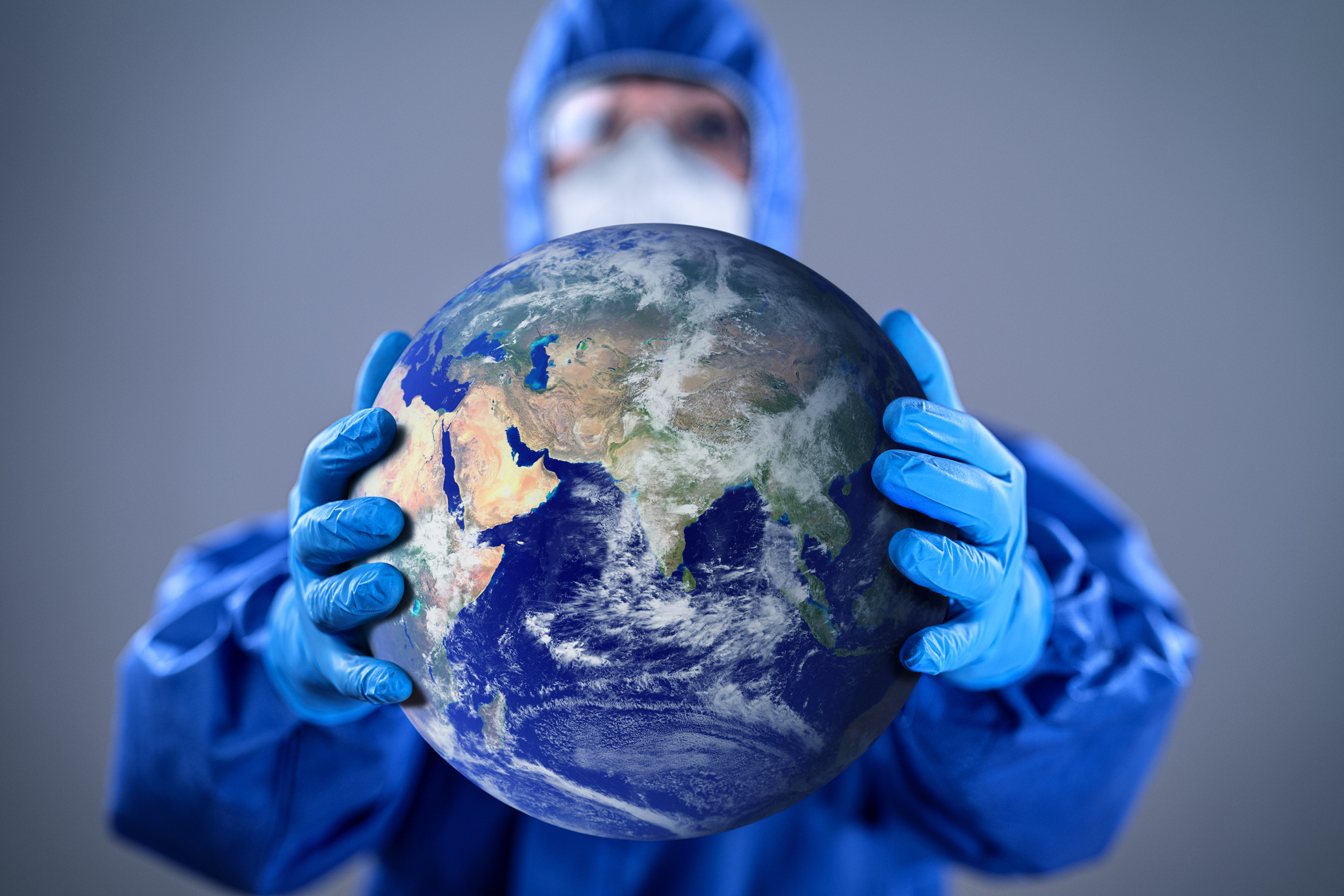 Doctor holding the globe/ Image credit: iStock