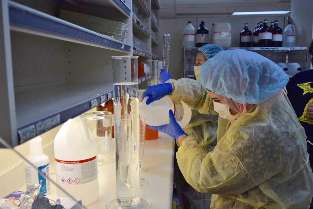A U-M school of pharmacy student prepares hand sanitizer.