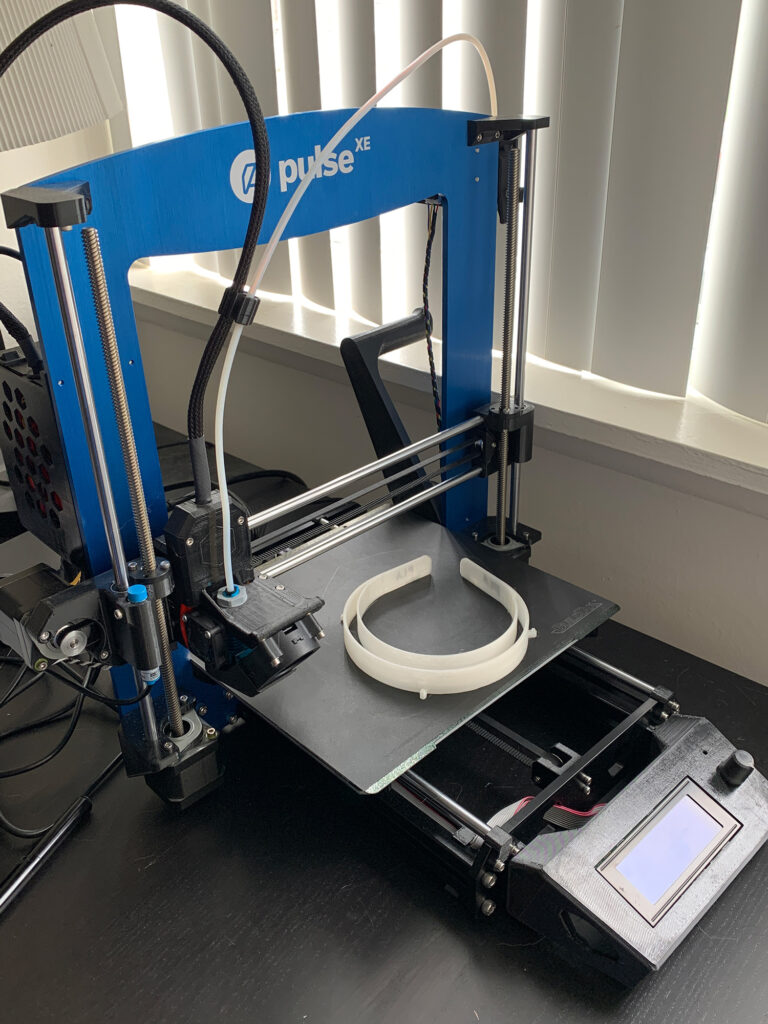 Photo of 3-D printer and faceshield headband