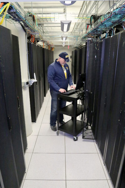 Brian Antosh, data center technical support analyst lead at the Michigan Academic Computing Center, helps to monitor and maintain performance of servers that support administrative and research needs across campus. (Photo by Joel Iverson, ITS Communications)