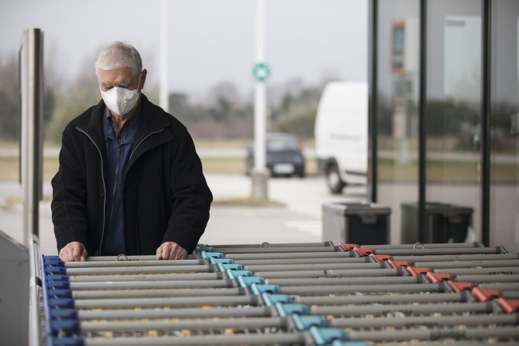 Senior man wearing a face mask at the supermarket. Image credit: iStock