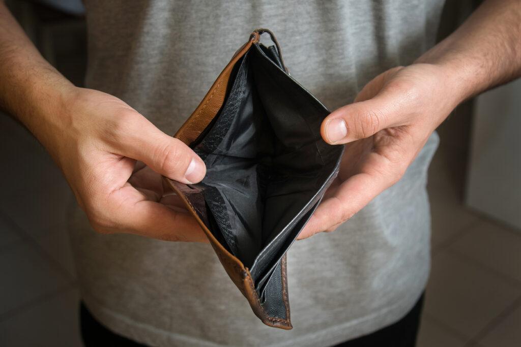 Holding an empty wallet. Image credit: iStock