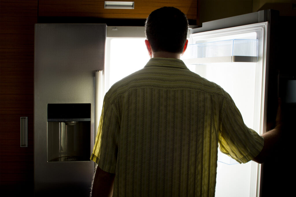 A man looks into an empty refridgerator. Image credit: iStock