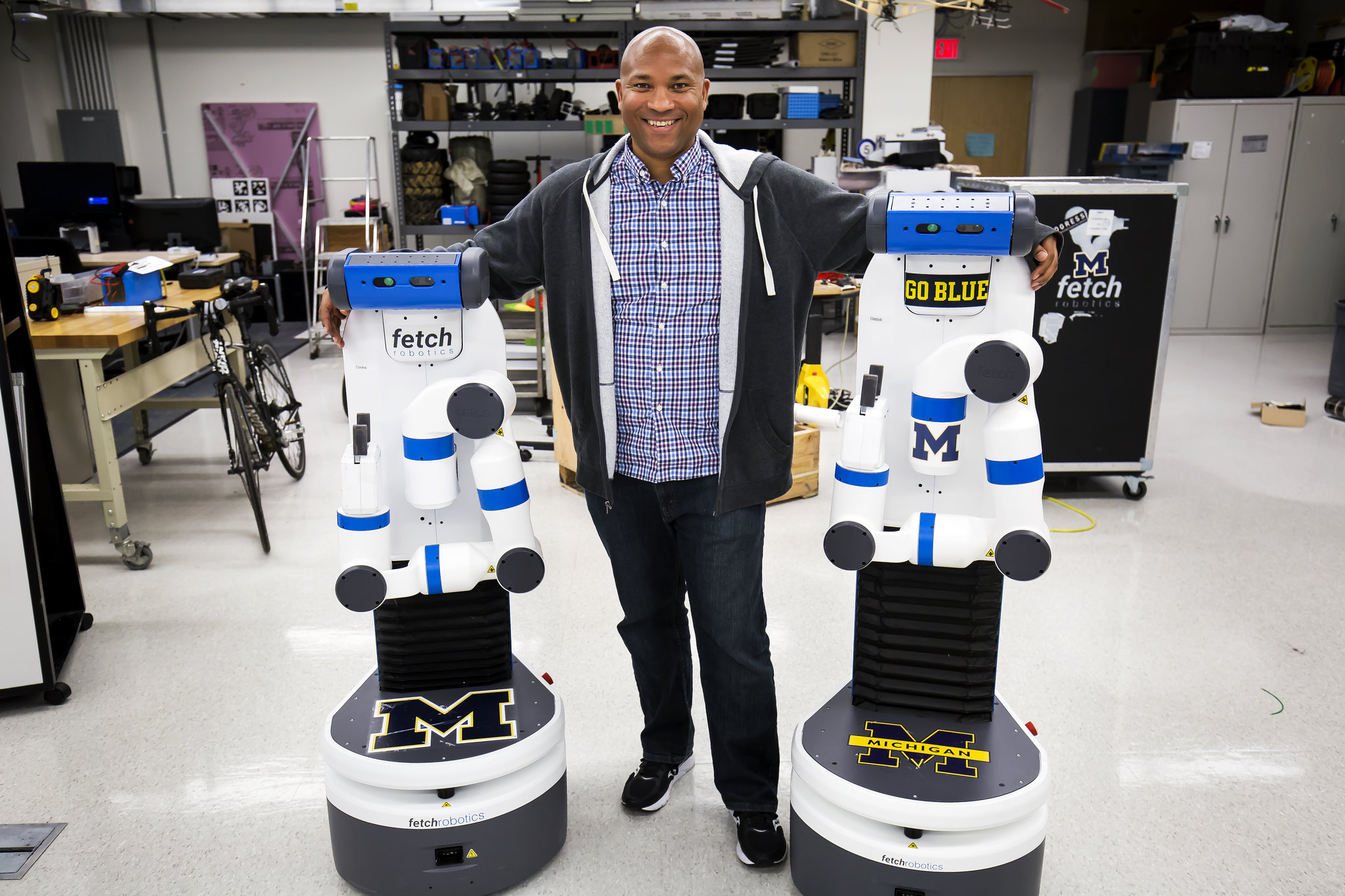 Chad Jenkins, CSE Associate Professor, poses with his research group's two robots, Odd Job and Cookie, in the Beyster Building on October 27, 2016. Image credit: Joseph Xu/Michigan Engineering Multimedia Content Producer, University of Michigan
