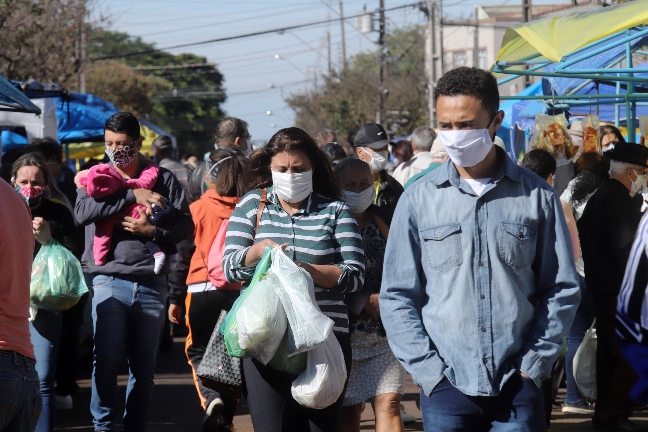 People all wearing a mask, to protect themselves from COVID-19. Image credit: iStock