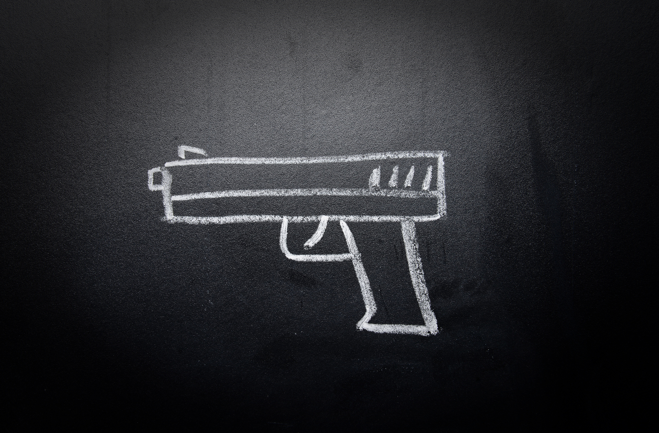 Weapon drawn on blackboard. Image credit: iStock