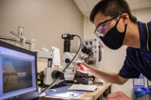 Yi Zhu, Graduate Student Research Assistant for Civil and Environmental Engineering, tests a new generation of micro-robotics inside Evgueni Filipov's lab at the G.G. Brown Building on North Campus, Ann Arbor Mi. on June 17, 2020. Image credit: Robert Coelius/University of Michigan Engineering, Communications & Marketing