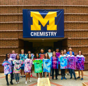 The 2019 group holds tie-dyed T-shirts they made on the last day of camp. Image credit: The McNeil Group
