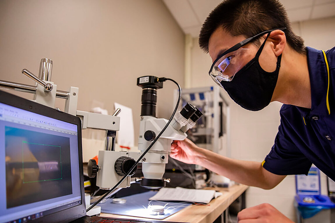 Yi Zhu, graduate student research assistant in civil and environmental engineering, tests a new generation of micro-robotics inside Evgueni Filipov’s lab at the G.G. Brown Building on North Campus. (Photo by Robert Coelius, College of Engineering)