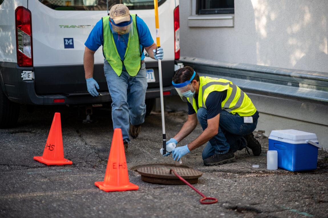 Philip Szornyi and Anthony Shourds of Environment, Health and Safety collect sewage samples behind U-M’s Campus Safety Services Building in August, before students began moving into residence halls.
Eric Bronson, Michigan Photography