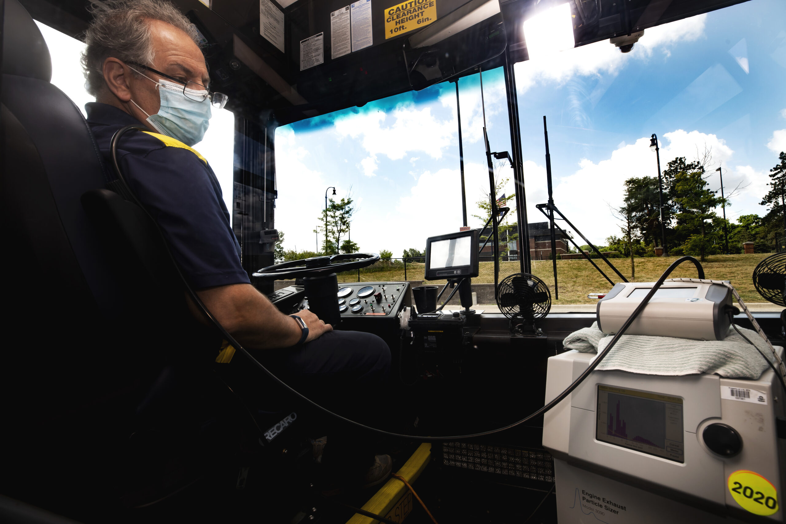 Andre Boehman, ME Associate Professor, and members of his research group test for the flow of aerosols in a University of Michigan blue bus in Ann Arbor, MI on June 24, 2020. Aerosols are liquid droplets in air that can be potential conduits for the coronavirus. Boehman and a team of researchers are measuring and modeling the concentration and dispersion of aerosols in buses in order to learn how to better filter them and keep users safe. Photo: Joseph Xu/Michigan Engineering, Communications & Marketing