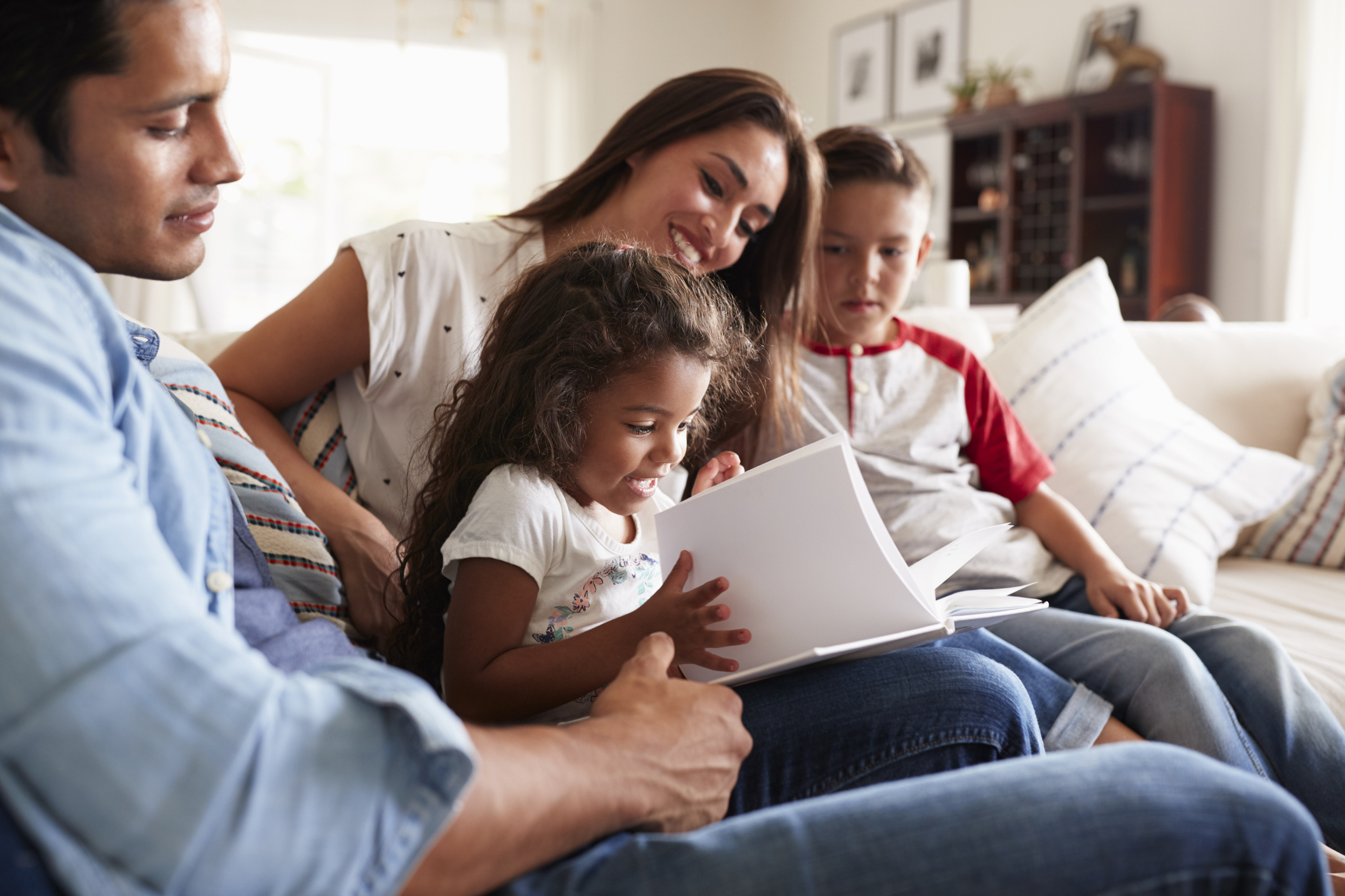 Young hispanic family of four. Image credit: iStock