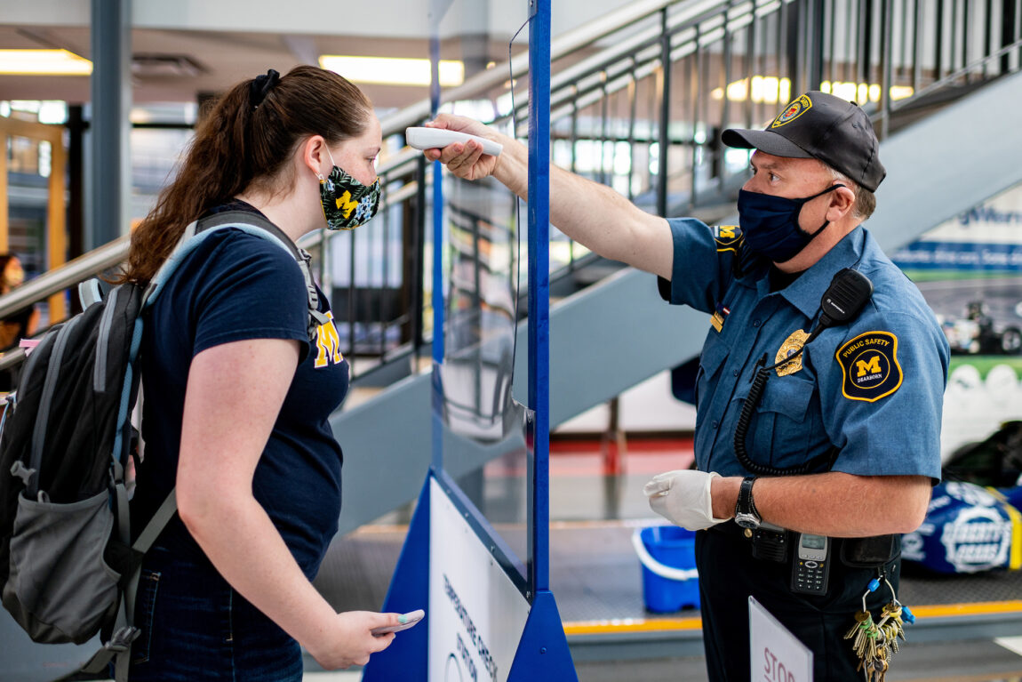 Photo of a UM-Dearborn student getting their temperature checked