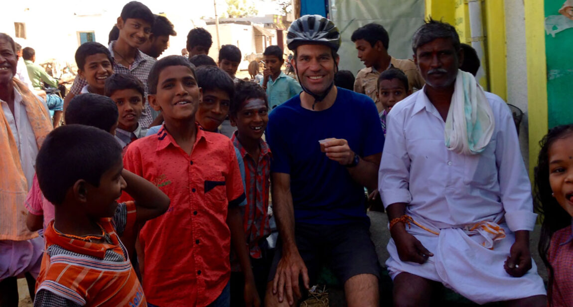 Stefan Koehler, associate director of licensing for U-M Tech Transfer, poses with children he met while riding his bicycle in India. (Photo courtesy of Stefan Koehler)