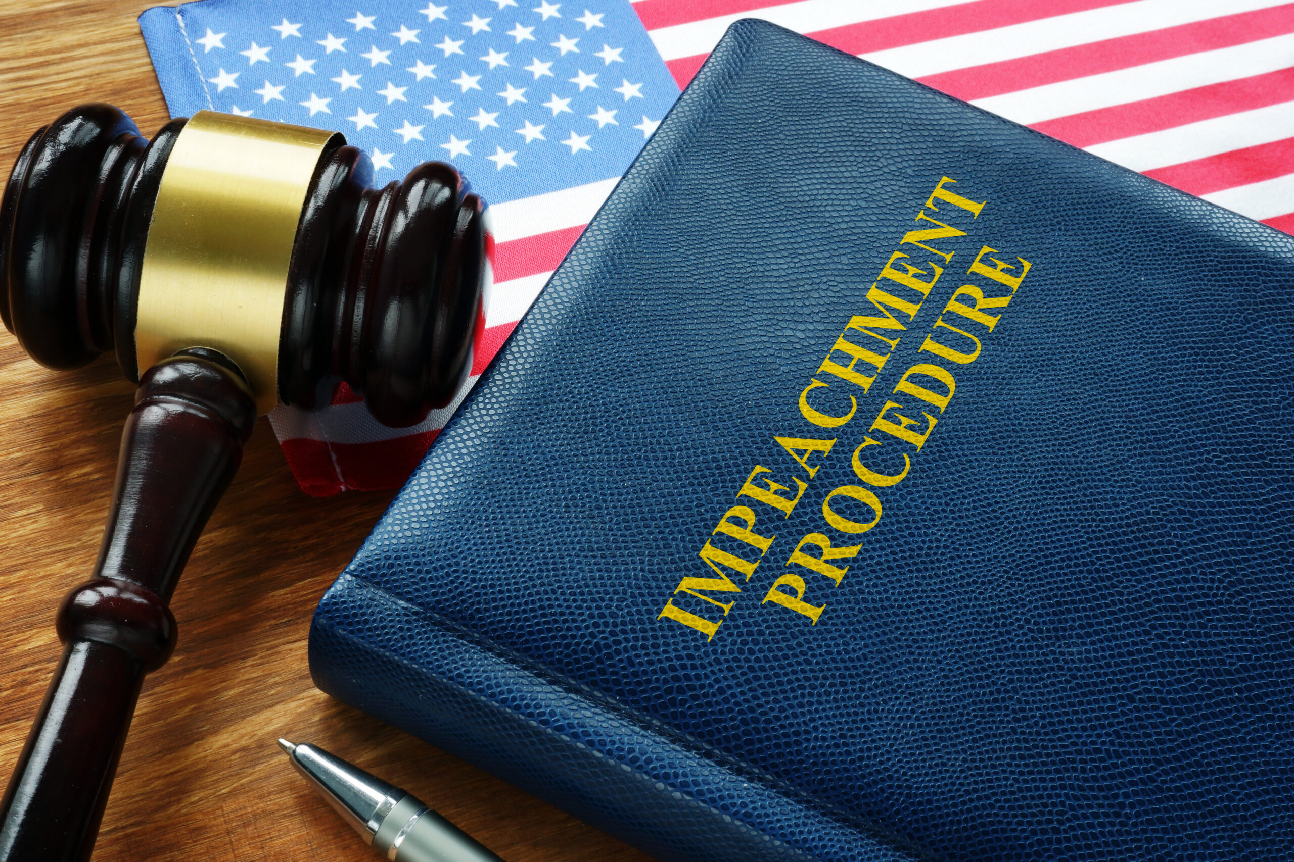 Impeachment procedure law, gavel and USA flag. Image credit: iStock