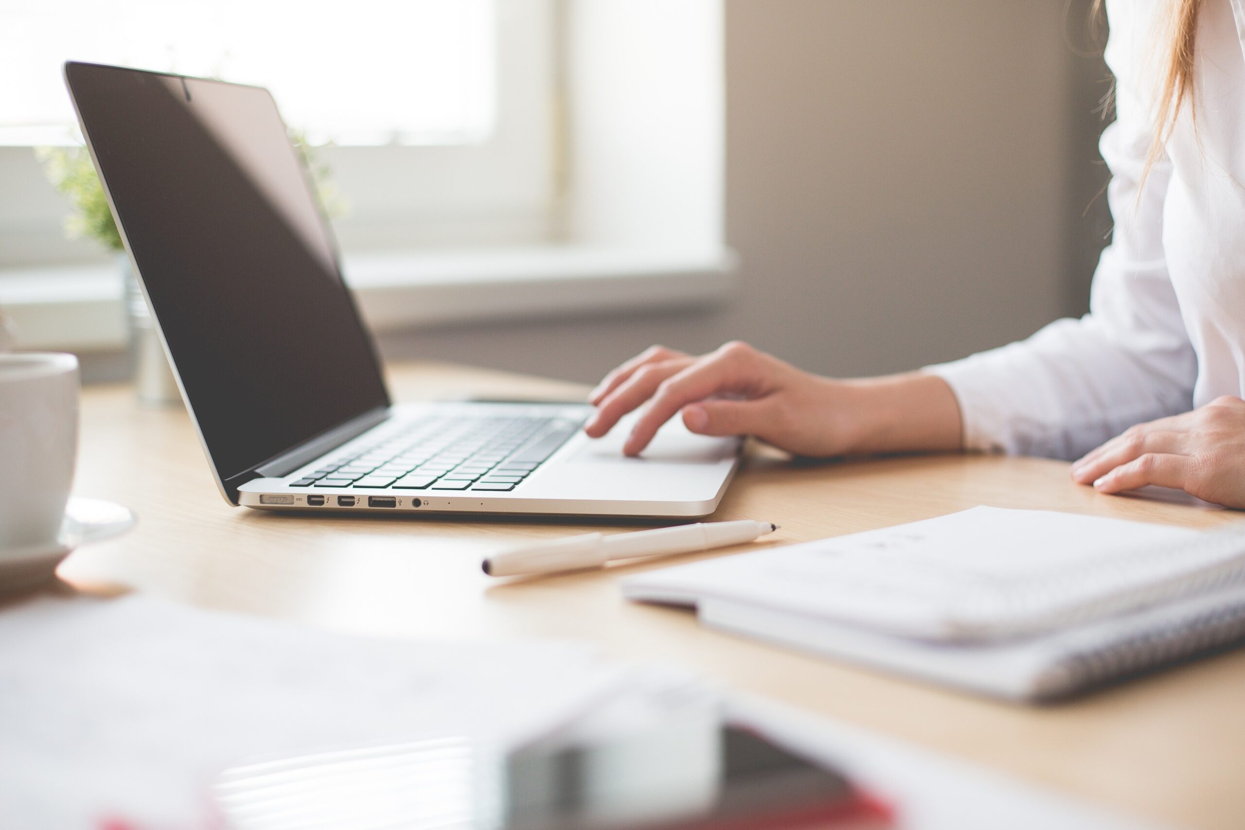 Person working at home on a computer. Image credit: Pexels