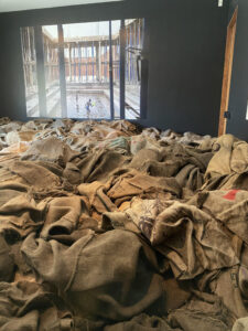 Jute sacks and photographs from Ibrahim Mahama’s Savannah Centre for Contemporary Art in Ghana comprise the installation at the Institute for the Humanities Gallery. To adhere to COVID restrictions, curator Amanda Krugliak made the gallery installation viewable from the sidewalk at 202 S. Thayer St. in downtown Ann Arbor.