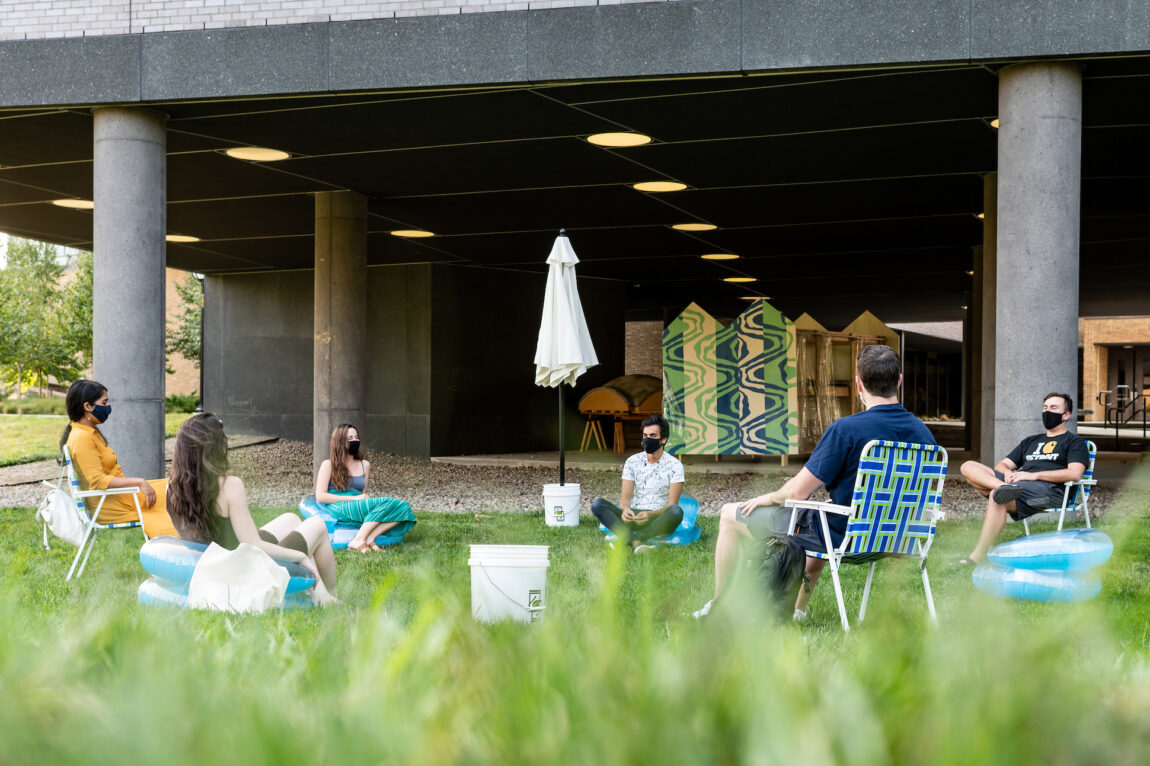 A variety of lawn furnishings are available for those who want to gather outdoors at a nearby hillside area known as "the beach."