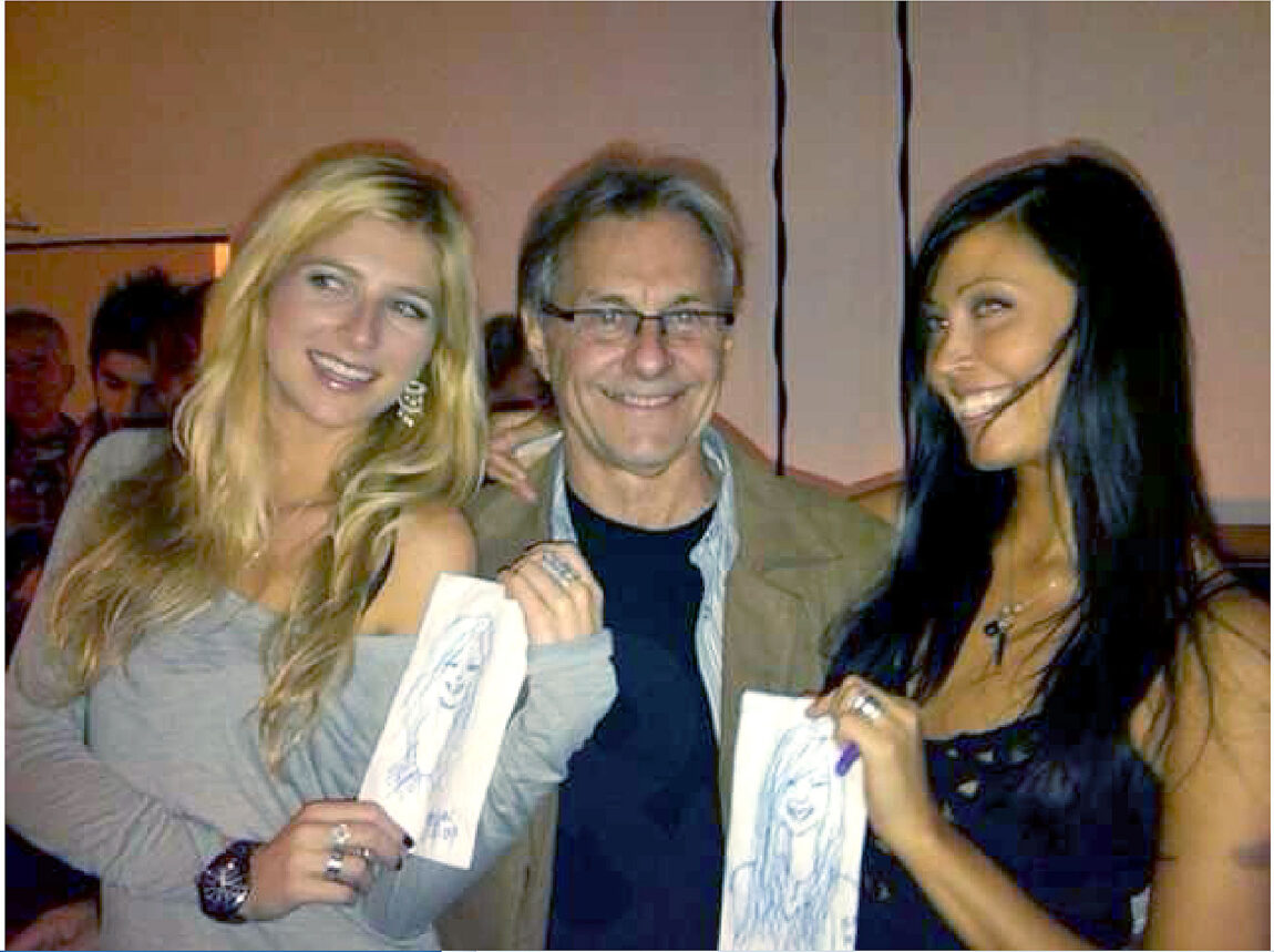 Gary Bohas poses with two women whose portraits he drew on napkins. He is putting together his most memorable portraits into a book called “Drawn2Dine.” (Photo courtesy of Gary Bohas)