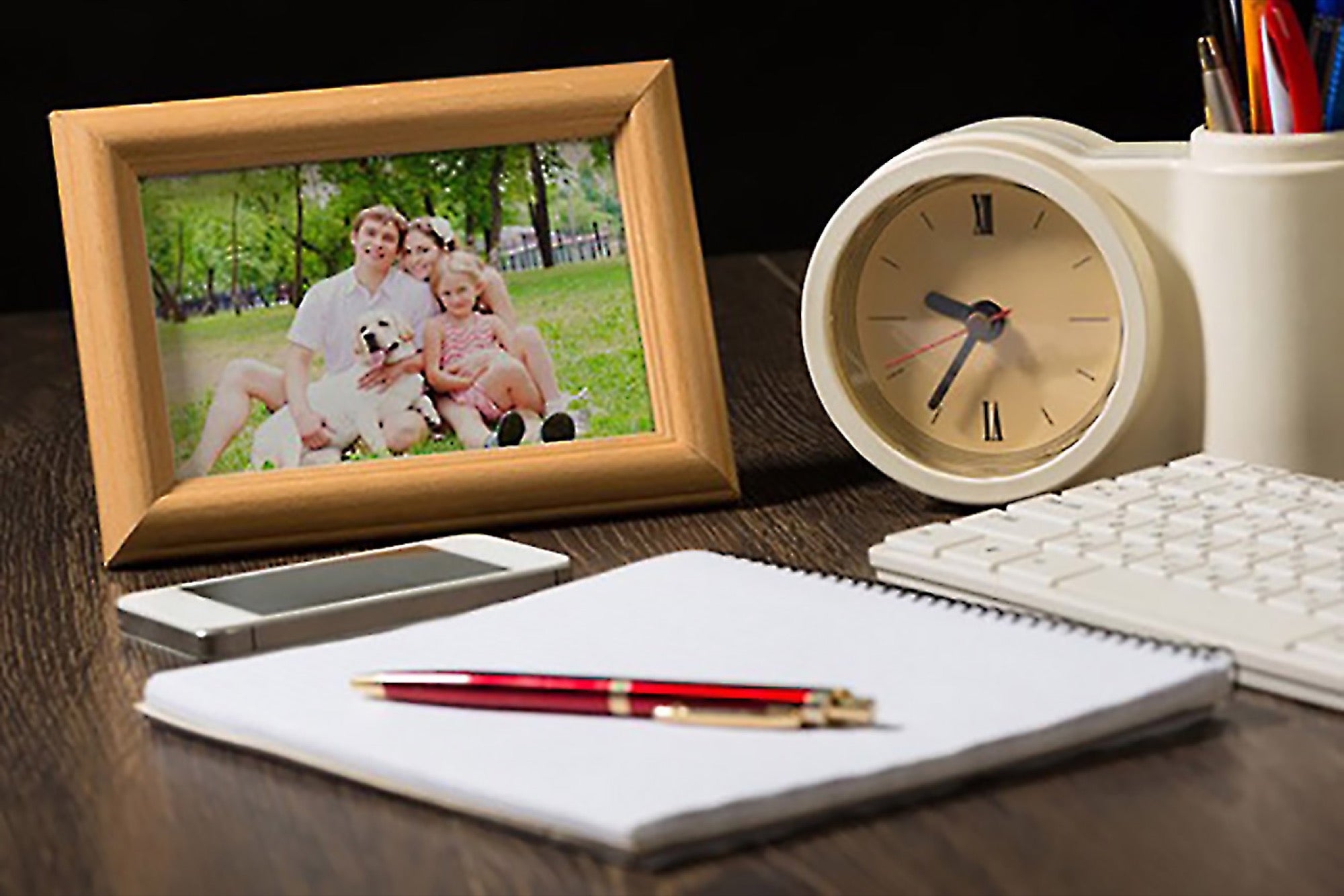 Stock image of framed family photo on a desk