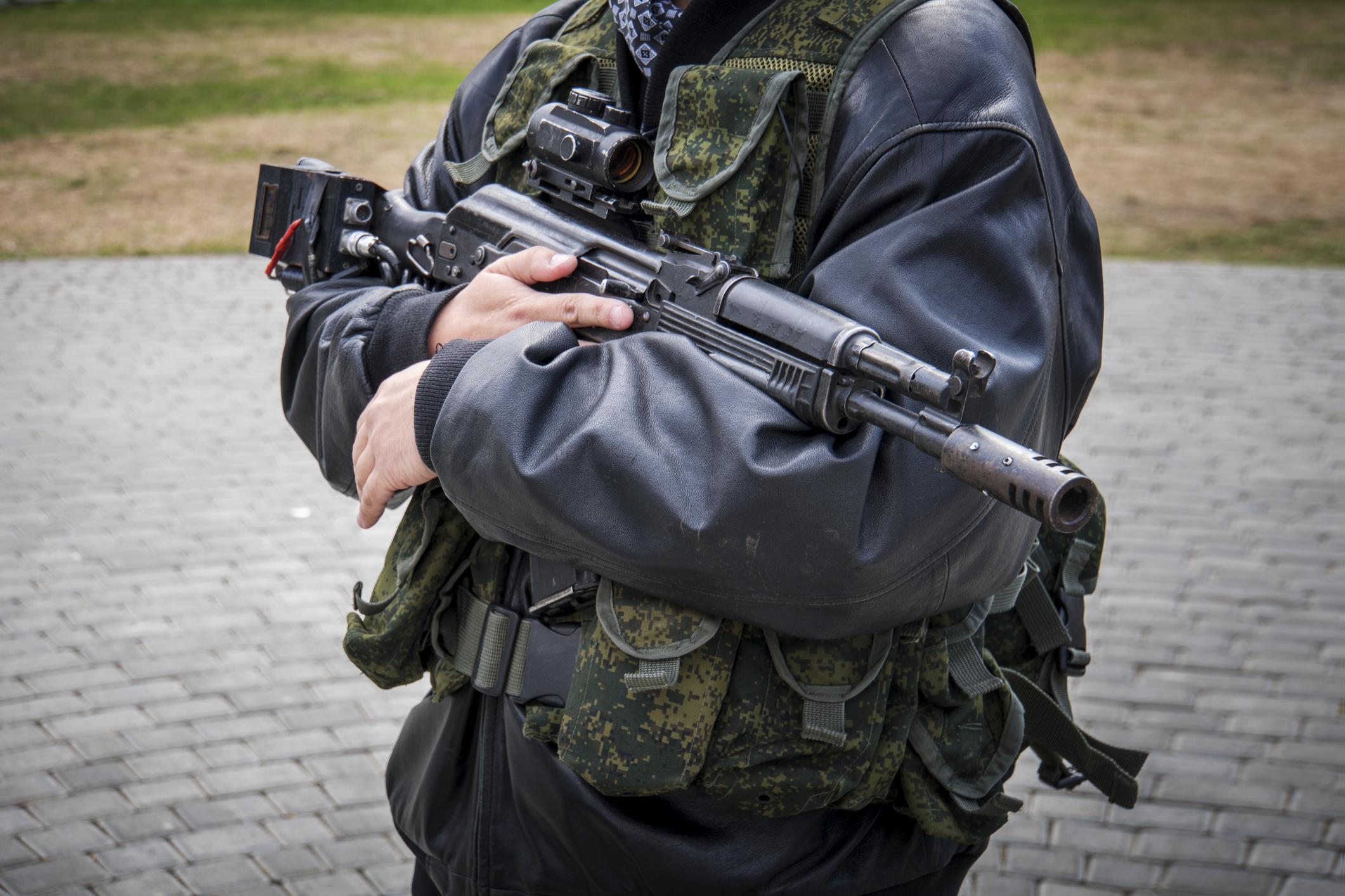 a man with a machine gun. male men's hands holding a rifle. Irregular troops. unprofessional military. Militiaman. Kalashnikov assault rifle with laser sniper scope. separatists. Image credit: Diy13