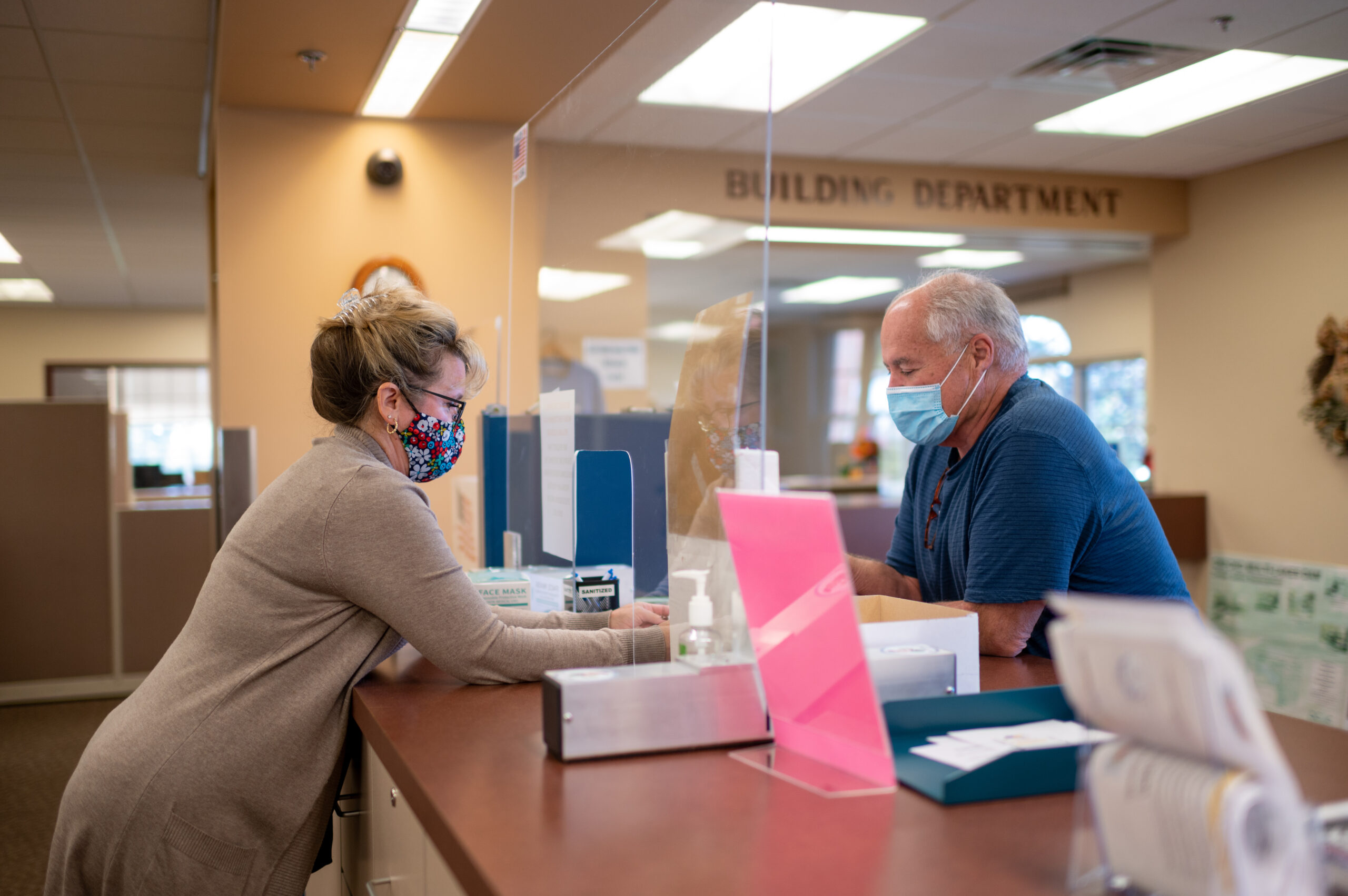 Kelly Richter, the clerk’s office administrative assistant in Oxford Township, assists a resident at the public counter. Image credit: Eric Bronson, Michigan Photography