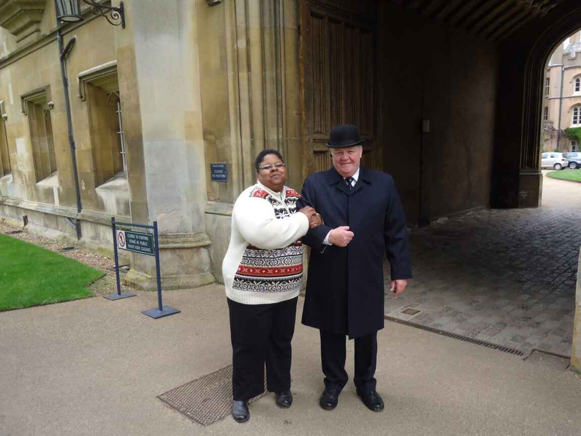 Monica Adams, head of user services at UM-Dearborn’s Mardigian Library, poses with a security guard at Trinity College Library in Cambridge, England, in 2013. Parts of the “Harry Potter” movies were filmed in the library. (Photo courtesy of Monica Adams)
