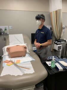 Brian Kaminski practicing a catheterization procedure using the HoloLens2. Image credit: U-M School of Nursing