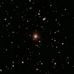 This image of Abell 2261 contains X-ray data from Chandra (pink) showing hot gas pervading the cluster as well as optical data from Hubble and the Subaru Telescope that show galaxies in the cluster and in the background. Astronomers used these telescopes to search galaxy in the center of the image for evidence of a black hole, weighing between 3 and 100 billion times the Sun, that is expected to be there. No sign of this black hole was found, deepening a mystery about what is happening in this system. Image credit: X-ray: NASA/CXC/Univ of Michigan/K. Gültekin ; Optical: NASA/STScI and NAOJ/Subaru; Infrared: NSF/NOAO/KPNO; Radio: NSF/NOAO/VLA