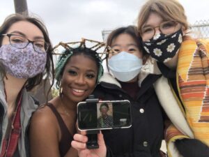 Left to right: University of Michigan students Kenzie Hill, Amber Cierra Merritt, Shannon Yeung, and Grace Klein pose with Ayana Evans during the shoot. Evans directed the entire day via Facetime from her home in New York. Image credit: Shannon Yeung.