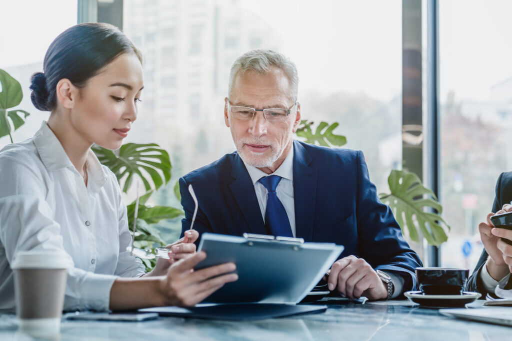 Business people working on papers. Image credit: iStock