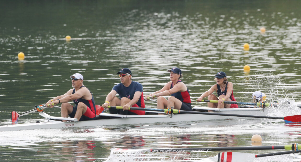 Mike Psarouthakis, second from left, and his wife, Lisa, second from right, compete in a co-ed race for the Ann Arbor Rowing Club. Psarouthakis, director of the U-M Tech Transfer Venture Center and managing director of the Accelerate Blue Fund, and his entire family participate in the sport of rowing. (Photo by Sport Graphics Inc.)