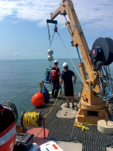 Researchers lower a robotic laboratory to the bottom of Lake Erie's central basin in July 2019 for a U-M-led study of phosphorus released from muddy lake-bottom sediments. Two of the autonomous labs were deployed: one at a depth of 67 feet and the other at a depth of 79 feet. (Photo by Hanna Anderson.)