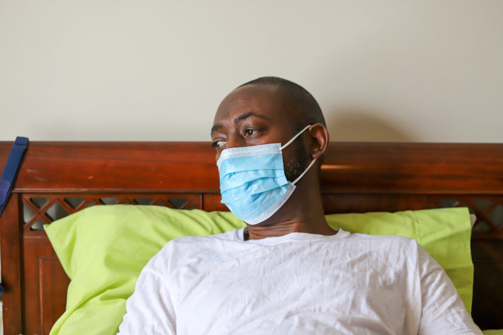An African-American man wearing a protective face mask to prevent virus infection. Image credit: Robin Gentry, iStock