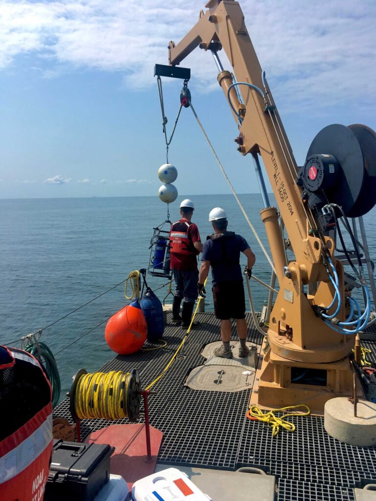 Researchers lower a robotic laboratory from the stern of a ship to the bottom of Lake Erie's central basin in July 2019 for a University of Michigan-led study of phosphorus released from muddy lake-bottom sediments. Two of the autonomous labs were deployed: one at a depth of 67 feet and the other at a depth of 79 feet. Image credit: Hanna Anderson
