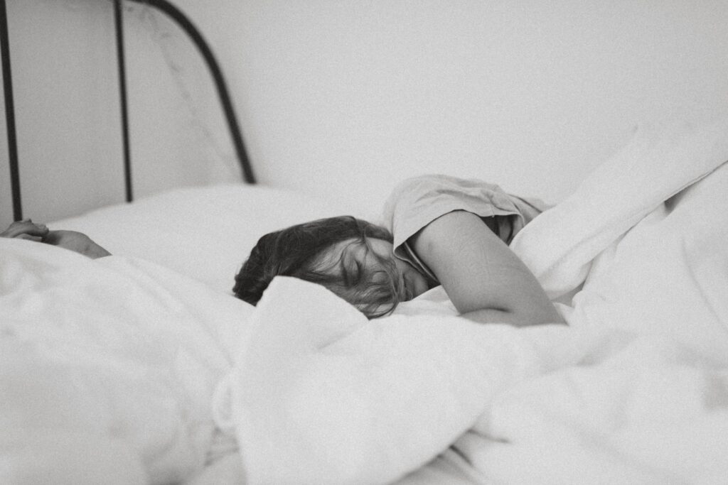 A woman sleeping. Image credit: Kinga Cichewicz, Unsplash