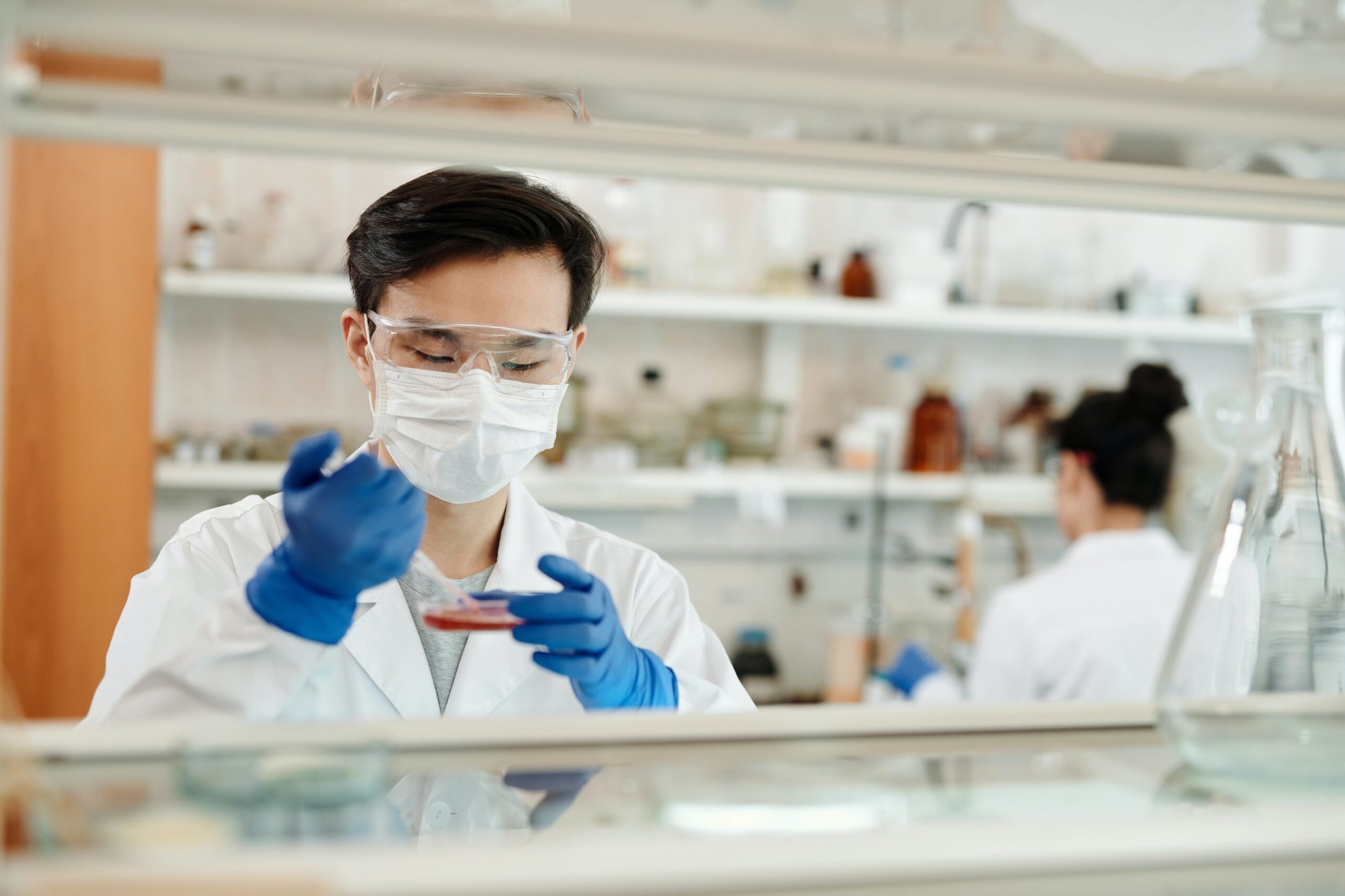Scientist in lab testing substance. Image credit: Pexels
