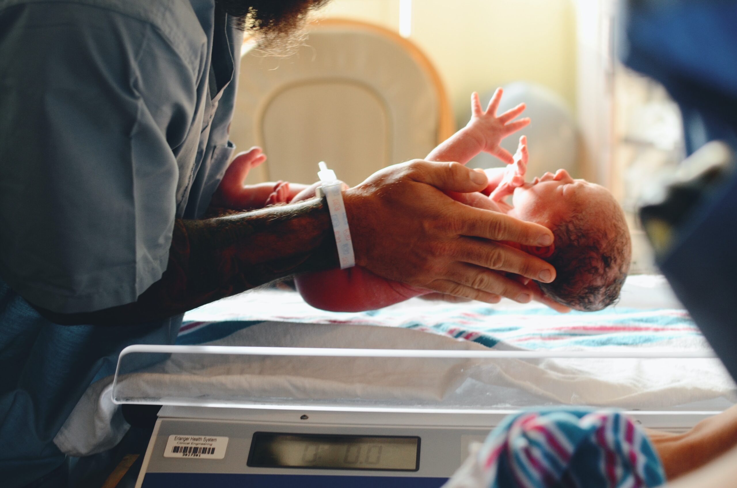 Nurse holding new born baby. Image credit: unsplash