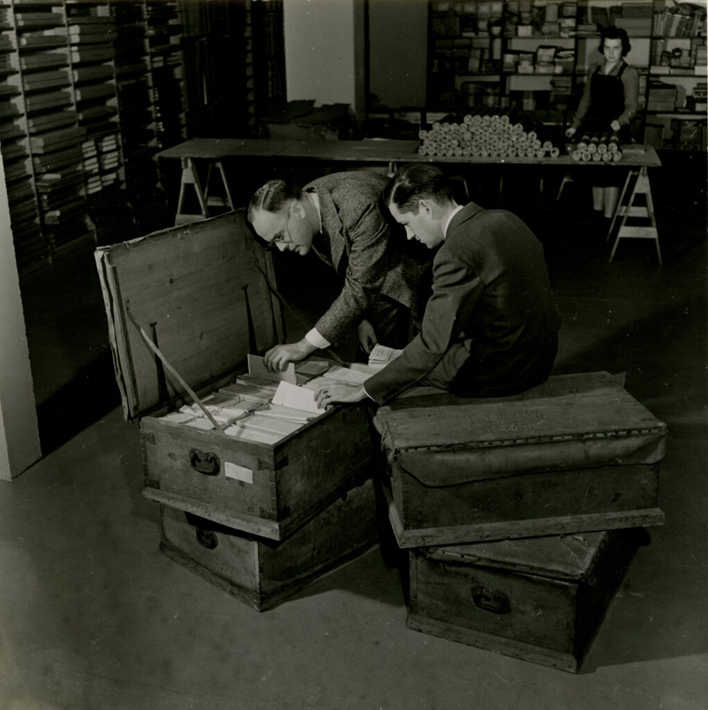 Curators and staff Lloyd Brown, Howard Peckham, and Margaret Webber with four trunks of Thomas Gage papers as they arrived at the William L. Clements Library in 1937. Image courtesy: William L. Clements Library