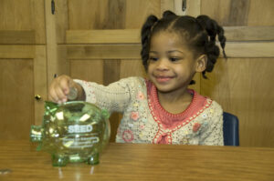 A student in the Head Start program in Pontiac learning about savings as part of the MI-SEED, or Saving for Education Entrepreneurship and Downpayment. Shanks was involved with the policy demonstration program in Michigan around child savings accounts from 2004 to 2009. Images courtesy: Trina Shanks