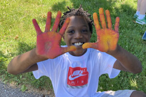 Cute boy with chalk on his palms