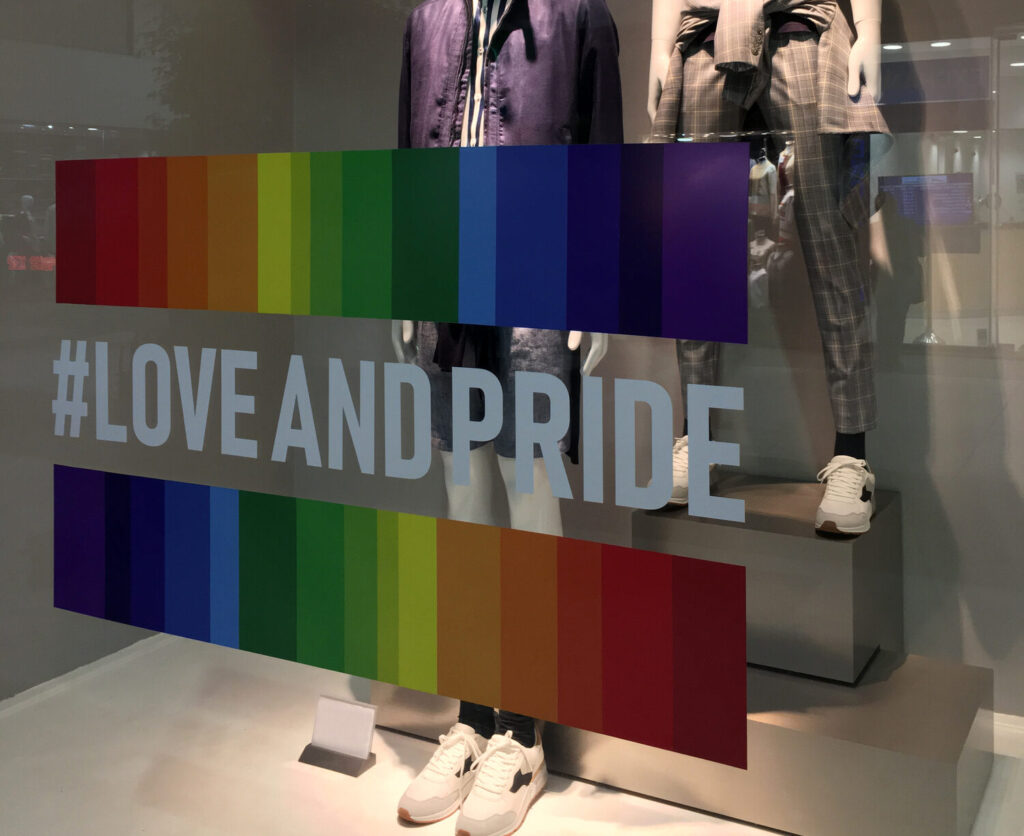 Buenos Aires, Argentina - November 8, 2018: Clothing store window with rainbow flag design over the glass as part of the celebration of the gay pride week in the city this month.