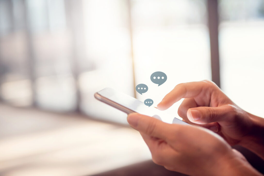 Women hands typing on mobile smartphone, Live Chat Chatting on application Communication Digital Web and social network Concept. copy space. Image credit: oatawa, iStock