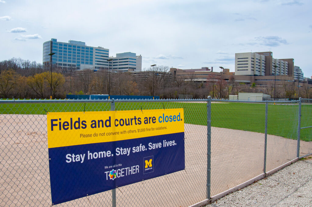 A sign alerts visitors fields and courts are closed April 27, 2020. (Photo by Henry Hedly, Michigan Medicine)