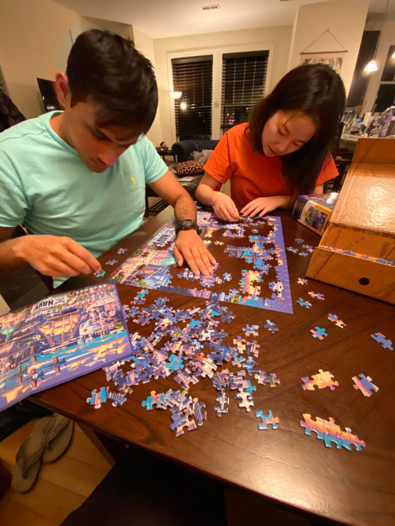 Students Rishabh Nayak, left, and Daphne Yao-Shin Wang work on a jigsaw puzzle to ward off boredom April 5, 2020. (Photo by Holly Reynolds)