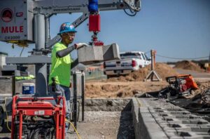 Barton Malow already uses simple robots on some job sites, such as the MULE, which helps workers place retaining wall block. The firm is a collaborator on a $2M, U-M led project that aims to enable robots to learn from and cooperate with human construction workers. Image credit: Construction Robotics