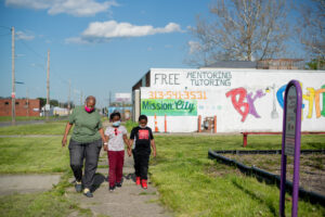 Cynthia Wells and her grandchildren Chase (8) and Chelsey Singeltary (9) have been taking music lessons for the last few years at Mission:City, a community center in Detroit's Brightmoor neighborhood. The classes are offered for free through Seven Mile, a University of Michigan student run organization that offers free after school music, art and coding lessons to kids in Detroit. Photo by Eric Bronson/Michigan Photography.