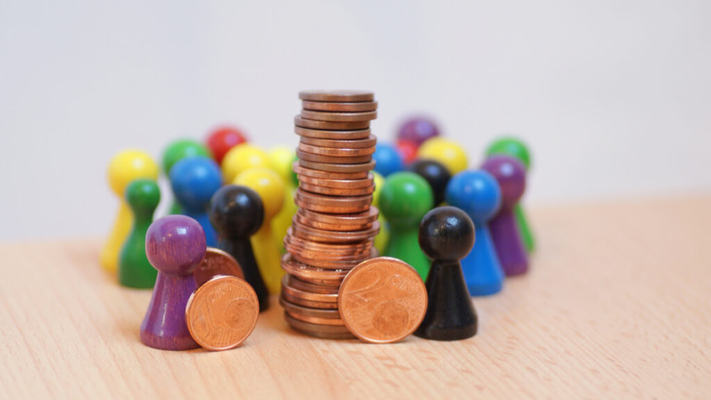 Concept image of pennies and figures representing people. Image courtesy: Ross School of Business